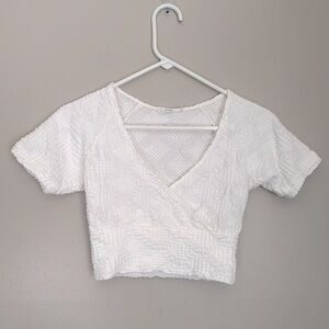 Reserved white textured wrap top